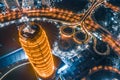 Modern buildings at night, city landmarks.