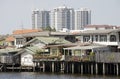 Modern buildings overpower old waterfront homes Bangkok Thailand