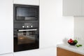 Modern built in oven with closed glass door on white kitchen Royalty Free Stock Photo