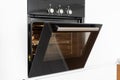 Modern built in oven with open glass door on white kitchen Royalty Free Stock Photo