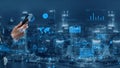 Modern Business Analytics and Data Visualization Using Smartphone Technology in Urban Landscape at Night with Digital Royalty Free Stock Photo