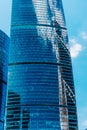 Modern business building. Clouds and buildings are reflected in the windows of the skyscraper of a commercial modern Royalty Free Stock Photo