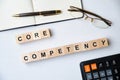 Modern business buzzword - core competency . Top view on wooden table with blocks. Top view