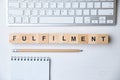 Modern business buzzword - fulfilment. Top view on wooden table with blocks. Top view