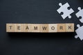 Modern business buzzword - teamwork. Top view on wooden table with blocks. Top view