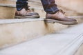 Modern business man working close-up legs walking down the stairs in modern city. Royalty Free Stock Photo