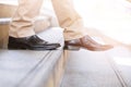 Modern business man working close-up legs walking down the stairs in modern city. Royalty Free Stock Photo