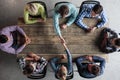 People sitting around table giving high five Royalty Free Stock Photo