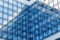 Modern business office building with glass facade and a blue sky reflection Royalty Free Stock Photo