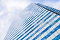 Modern business office building with glass windows reflect the skyline that view from below in Bangkok, Thailand Royalty Free Stock Photo