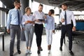 Modern business people discussing business and smiling while walking through the office corridor Royalty Free Stock Photo