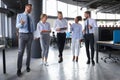 Modern business people discussing business and smiling while walking through the office corridor Royalty Free Stock Photo