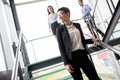 Modern business people walking on stairs in glass hall in office building Royalty Free Stock Photo