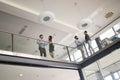 Modern business people walking on stairs in glass hall in office Royalty Free Stock Photo