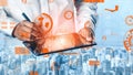 Modern Business Professional Using Digital Tablet for Data Analytics with Futuristic Graphics Over a Cityscape Royalty Free Stock Photo