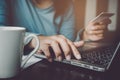 Close up hands of woman using computer and credit card paying bills for online ordering Royalty Free Stock Photo