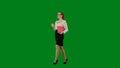 Portrait of attractive office girl on chroma key green screen. Woman in skirt and glasses walking holding red folder and Royalty Free Stock Photo