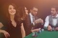 Modern business woman sitting at craps table in a casino. Royalty Free Stock Photo