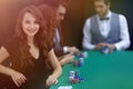 Modern business woman sitting at craps table in a casino. Royalty Free Stock Photo