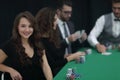 Modern business woman sitting at craps table in a casino. Royalty Free Stock Photo