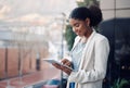 Modern business woman on a tablet during a work break alone outside. Smiling corporate worker looking at web and social Royalty Free Stock Photo