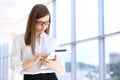 Modern business woman typing on laptop computer while standing in the office before meeting or presentation Royalty Free Stock Photo