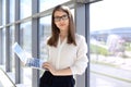 Modern business woman typing on laptop computer while standing in the office before meeting or presentation Royalty Free Stock Photo