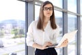 Modern business woman typing on laptop computer while standing in the office before meeting or presentation Royalty Free Stock Photo