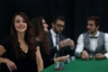 Modern business woman sitting at craps table in a casino. Royalty Free Stock Photo