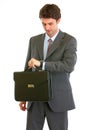 Modern businessman with briefcase checking time Royalty Free Stock Photo