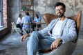 Modern businessman with a laptop sitting in a stylish comfortable chair Royalty Free Stock Photo