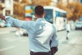 Modern businessman is pulling his hand up to the bus Royalty Free Stock Photo