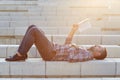 Modern businessman reading outdoors