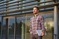 Modern businessman standing outside office