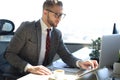 Modern businessman using laptop while sitting in the office