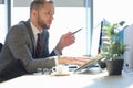 Modern businessman using laptop while sitting in the office