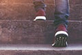 Modern businessman working close-up legs walking up the stairs in modern city. Royalty Free Stock Photo