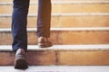 Modern businessman working close-up legs walking up the stairs in modern city. in rush hour to work in office a hurry.