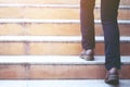 Modern businessman working  close-up legs walking up the stairs in modern city. in rush hour to work in office a hurry. Royalty Free Stock Photo