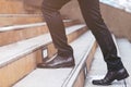 Modern businessman working  close-up legs walking up the stairs in modern city. soft focus. Royalty Free Stock Photo