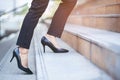 Modern businesswoman working woman close up legs walking up the stairs in modern city in rush hour to work in office a hurry. Duri Royalty Free Stock Photo