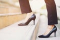 Modern businesswoman working woman close-up legs walking up the stairs in modern city. Royalty Free Stock Photo