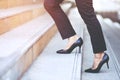 Modern businesswoman working woman close up legs walking up the stairs in modern city in rush hour to work in office a hurry. Duri Royalty Free Stock Photo