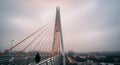 Modern Cable-Stayed Bridge with Person Walking Across on a Cloudy Day Royalty Free Stock Photo