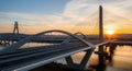 Modern Cable-Stayed Bridge at Sunset with Unique Arch and Tower Design Royalty Free Stock Photo