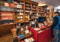 Modern cafe inside old bookstore with readers and people buying snacks for breakfast