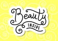 Modern calligraphy lettering of Beauty inside in black with white outline on yellow background with swirls