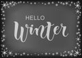 Modern calligraphy lettering of Hello Winter in white on blackboard background with frame of stars and snowflakes