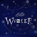 Modern calligraphy lettering of Hello winter in white on dark blue background decorated with silver snowflakes and pearls Royalty Free Stock Photo