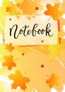 Notebook in black on orange yellow background decorated with orange frame, maple leaves and red dots